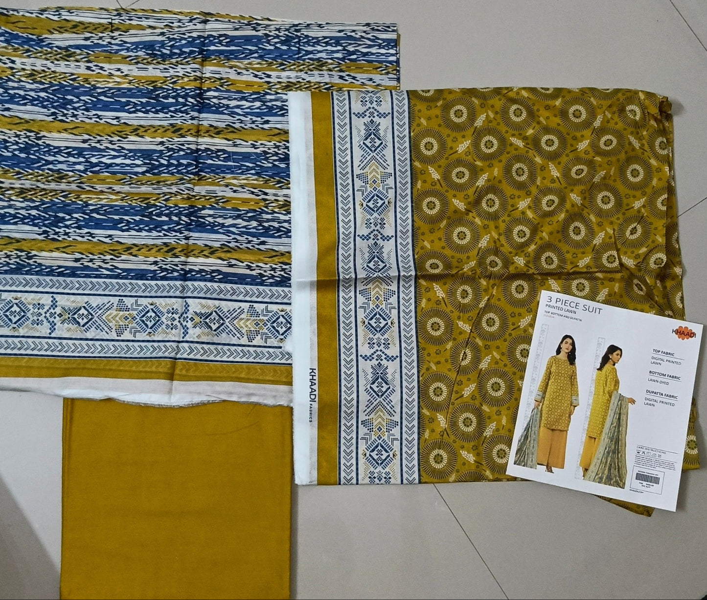 Fabric swatches with patterns on a tiled floor
